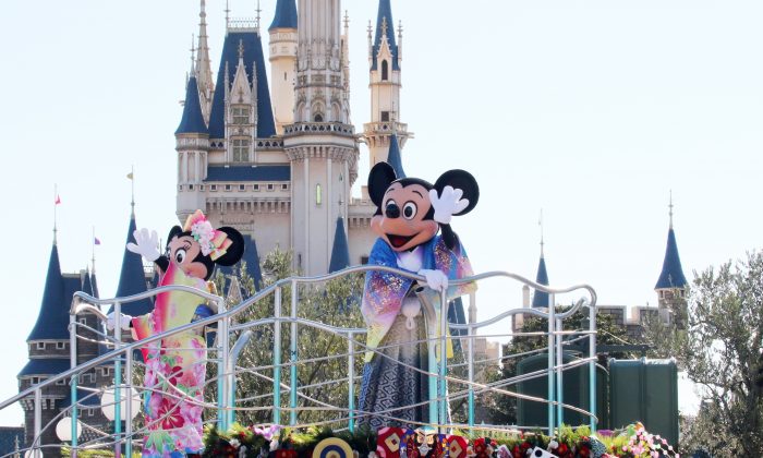 Disney characters Mickey (C) and Minnie Mouse (L), dressed in traditional Japanese kimonos, wave to greet guests from a float during the theme park's annual New Year's Day parade at Tokyo Disneyland in Urayasu, suburban Tokyo on January 1, 2016. The time around New Year's Day is one of the biggest holiday periods every year in Japan.      AFP PHOTO / Yoshikazu TSUNO / AFP / YOSHIKAZU TSUNO        (Photo credit should read YOSHIKAZU TSUNO/AFP/Getty Images)
