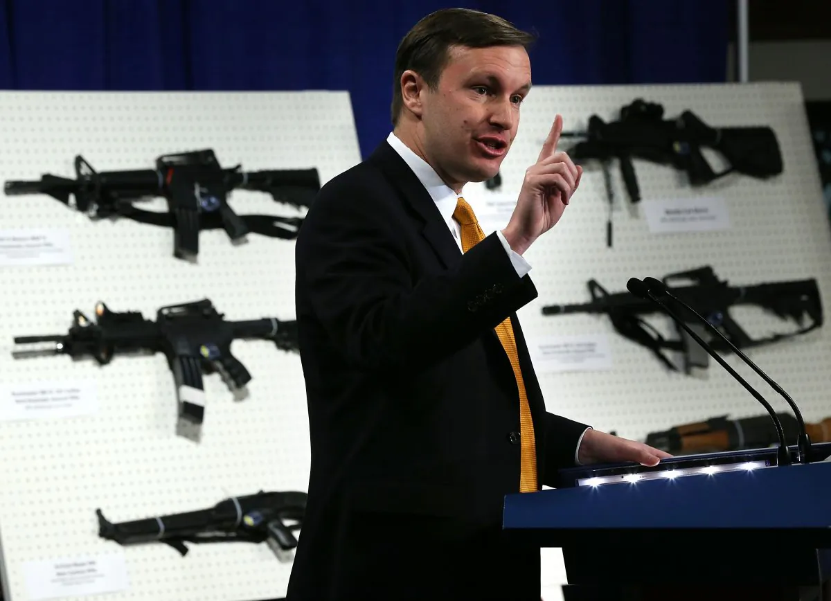 U.S. Senator Chris Murphy (D-CT) speaks next to a display of assault weapons during a news conference January 24, 2013 on Capitol Hill in Washington, DC. U.S. Senator Dianne Feinstein (D-CA) announced that she will introduce a bill to ban assault weapons and high-capacity magazines capable of holding more than 10 rounds to help to stop gun violence. (Alex Wong/Getty Images)