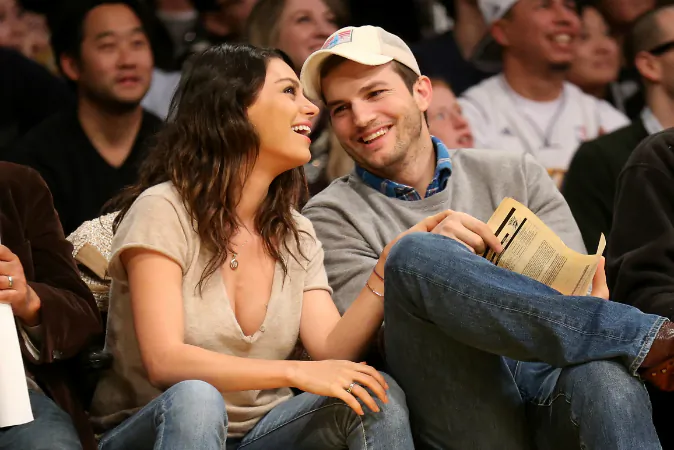 Actors Ashton Kucher and Mila Kunis attend the game between the Oklahoma City Thunder and the Los Angeles Lakers at Staples Center on December 19, 2014 in Los Angeles, California. (Stephen Dunn/Getty Images)
