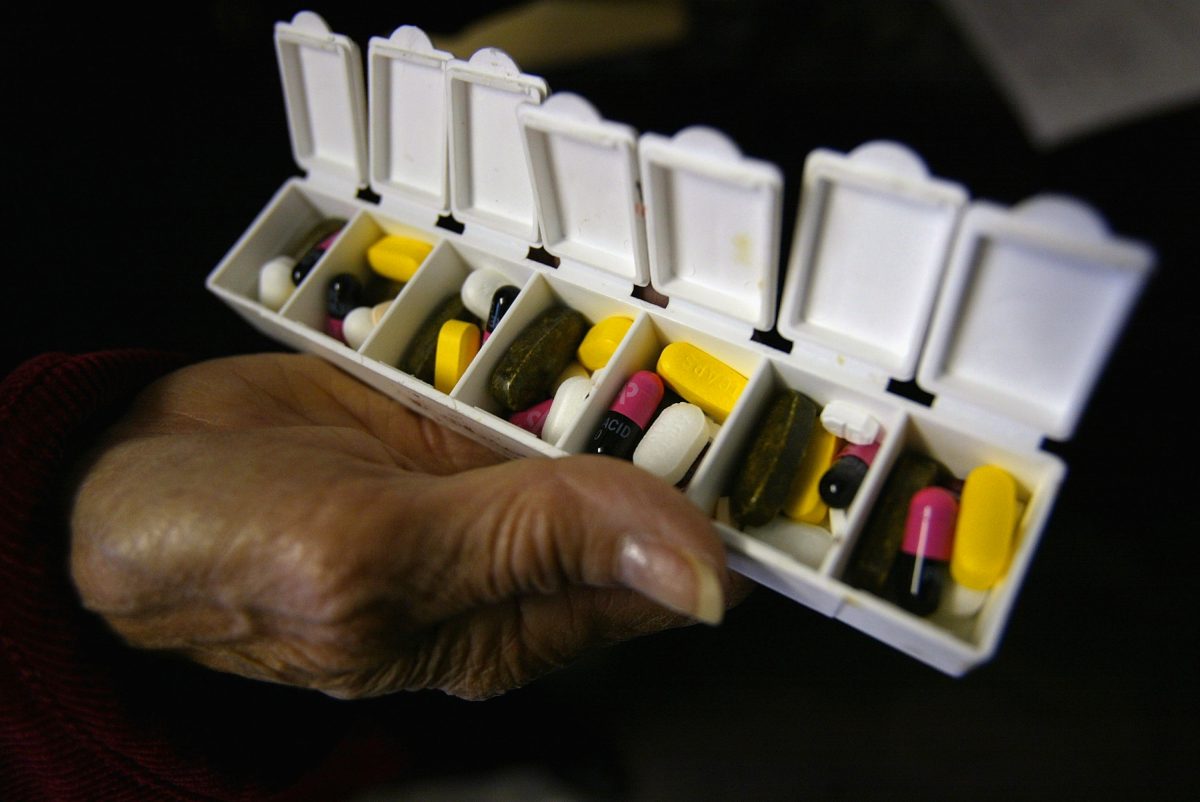 A woman displays a box of pills for her asthma and high blood pressure condition in New York City on Oct. 12, 2004. (Spencer Platt/Getty Images)