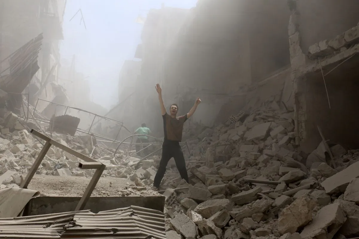 A man gestures amid the rubble of destroyed buildings following a reported airstrike on the rebel-held neighborhood of al-Kalasa in the northern Syrian city of Aleppo, on April 28, 2016. (Ameer Alhalbi/AFP/Getty Images)