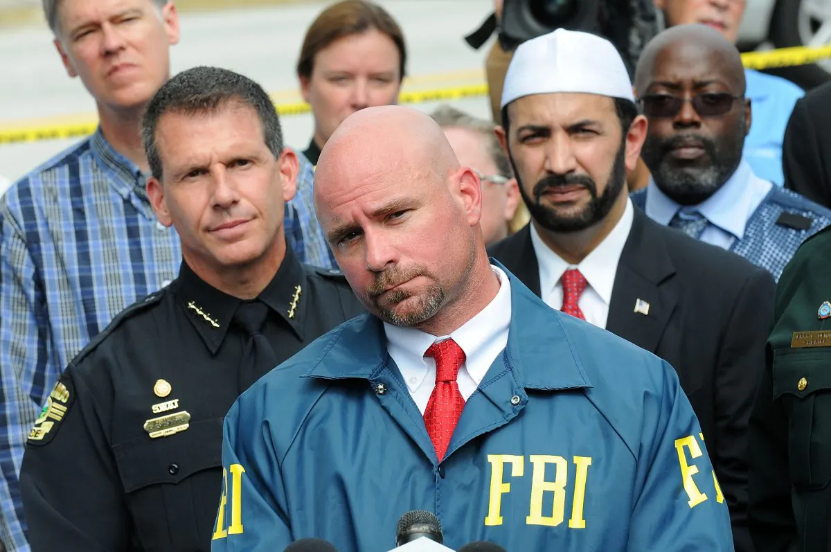 FBI assistant special agent in charge Ron Hopper (C), law enforcement and local community leaders speak during a press conference in Orlando, Fla., on June 12, 2016. (Gerardo Mora/Getty Images)