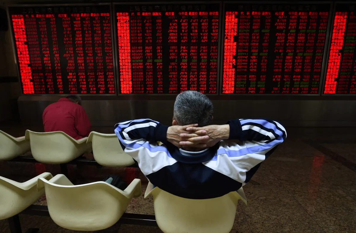 An investor watches stock price movements at a securities company in Beijing on June 15. (Greg Baker/AFP/Getty Images)