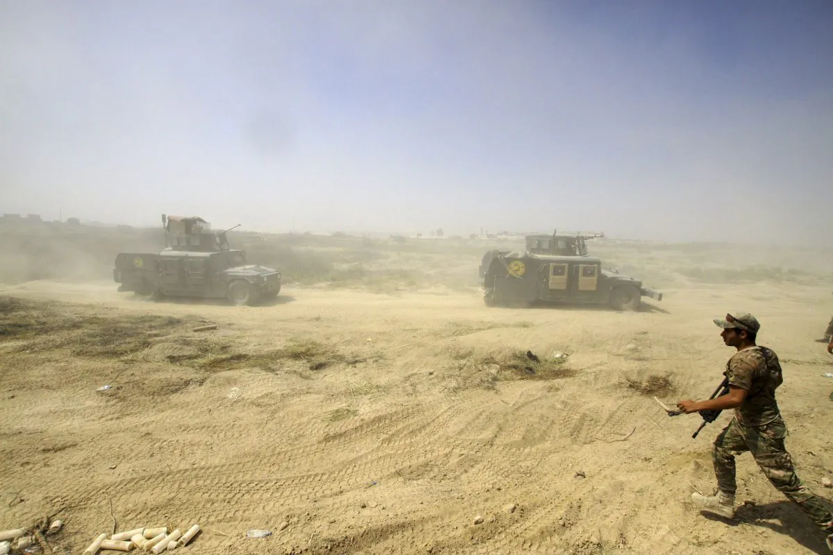 Iraqi security forces advance their positions during the fight against Islamic State militants in Fallujah, Iraq, on June 15, 2016. (AP Photo/Anmar Khalil)