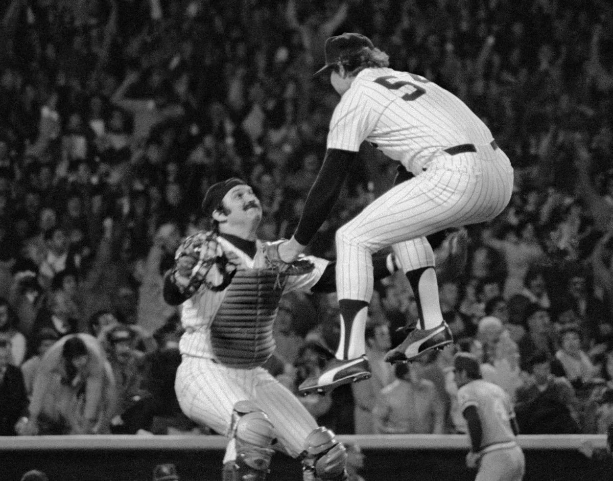 New York Yankees closer Goose Gossage (R) leaps into the arms of catcher Thurman Munson after beating the Kansas City Royals 2–1 in Game 4 to win the ALCS. (AP Photo/Richard Drew)