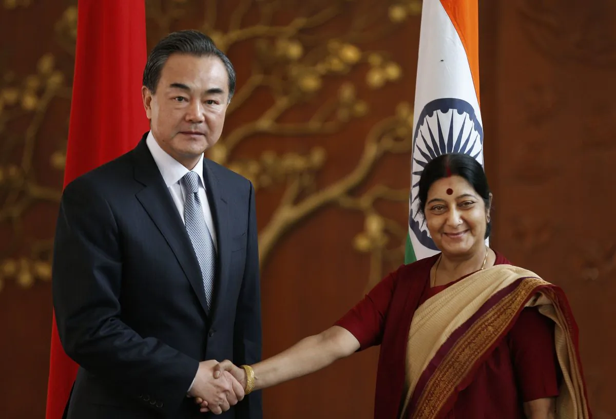 Indian External Affairs Minister Sushma Swaraj (R) shakes hands with her Chinese counterpart Wang Yi before their meeting in New Delhi, India, on June 8, 2014. (AP Photo/Saurabh Das)
