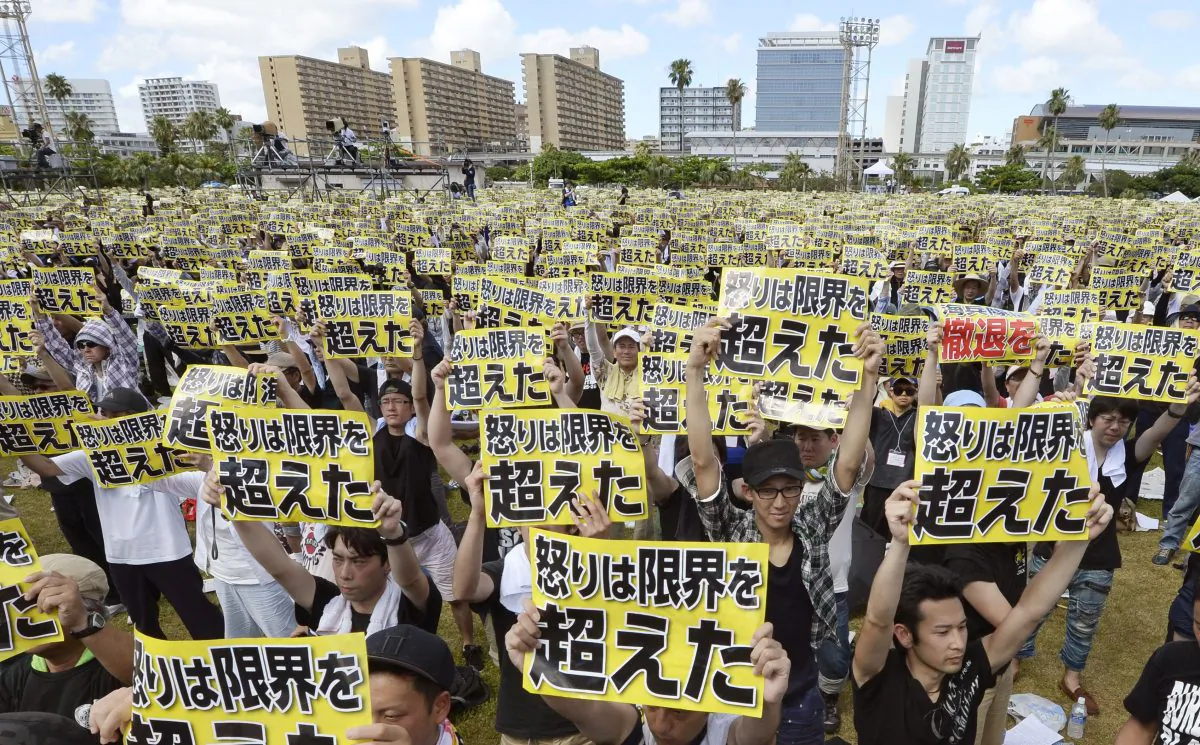 Protesters hold placards that read: "Our anger has reached its limit" during a protest rally against the presence of U.S. military bases on the southwestern island of Okinawa in Naha, Okinawa, on June 19, 2016 as many of them wearing black to mourn the rape and killing of a local woman in which a former U.S. Marine is a suspect. The rally called for a review of the U.S.-Japanese security agreement, which burdens Okinawa with hosting the bulk of American troops in Japan. (Ryosuke Uematsu/Kyodo News via AP)