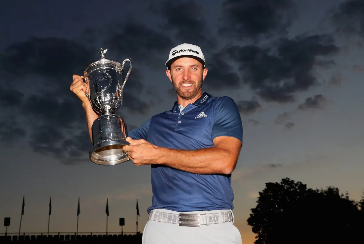 Dustin Johnson poses with the winner's trophy after winning the U.S. Open at Oakmont Country Club on June 19 in Oakmont, Pennsylvania. (Andrew Redington/Getty Images) 