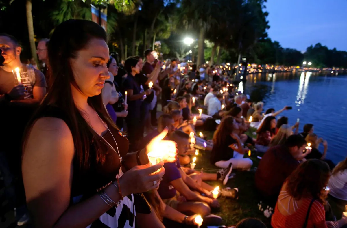 Supporters of the victims of the recent mass shooting at the Pulse nightclub attend a vigil at Lake Eola Park, in Orlando, Fla., on June 19. Tens of thousands of people attended the vigil. (AP Photo/John Raoux)