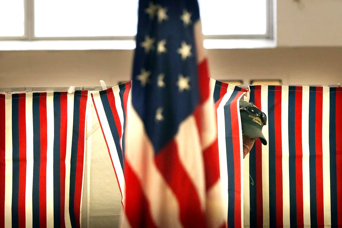 A man exits a voting booth inside a middle school serving as a voting station on the day of the New Hampshire Primary in Bow, N.H., on Feb. 9, 2016. (Spencer Platt/Getty Images)