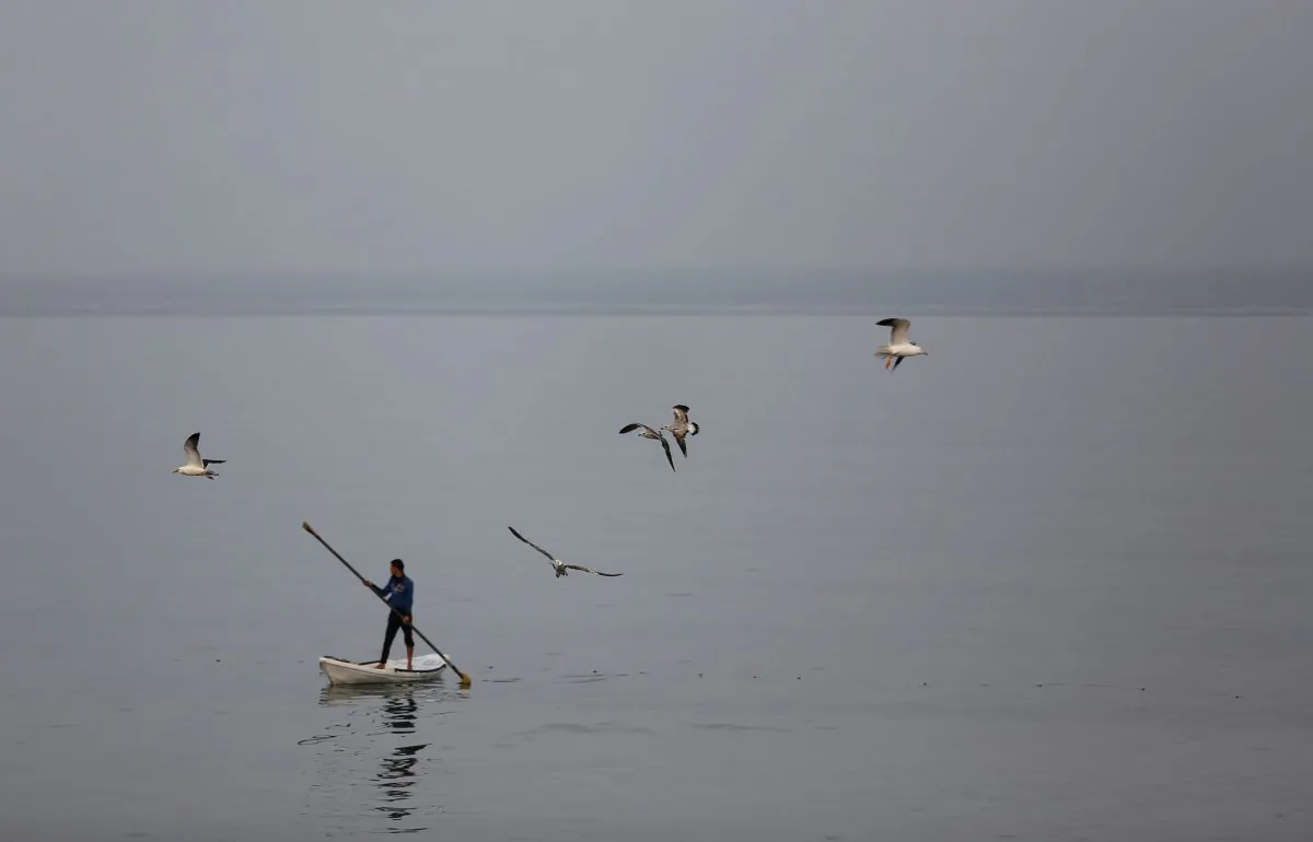A Palestinian fisherman rides a boat on a foggy day in the Mediterranean Sea off the coast of Gaza City on April 5, 2016. (MOHAMMED ABED/AFP/Getty Images)