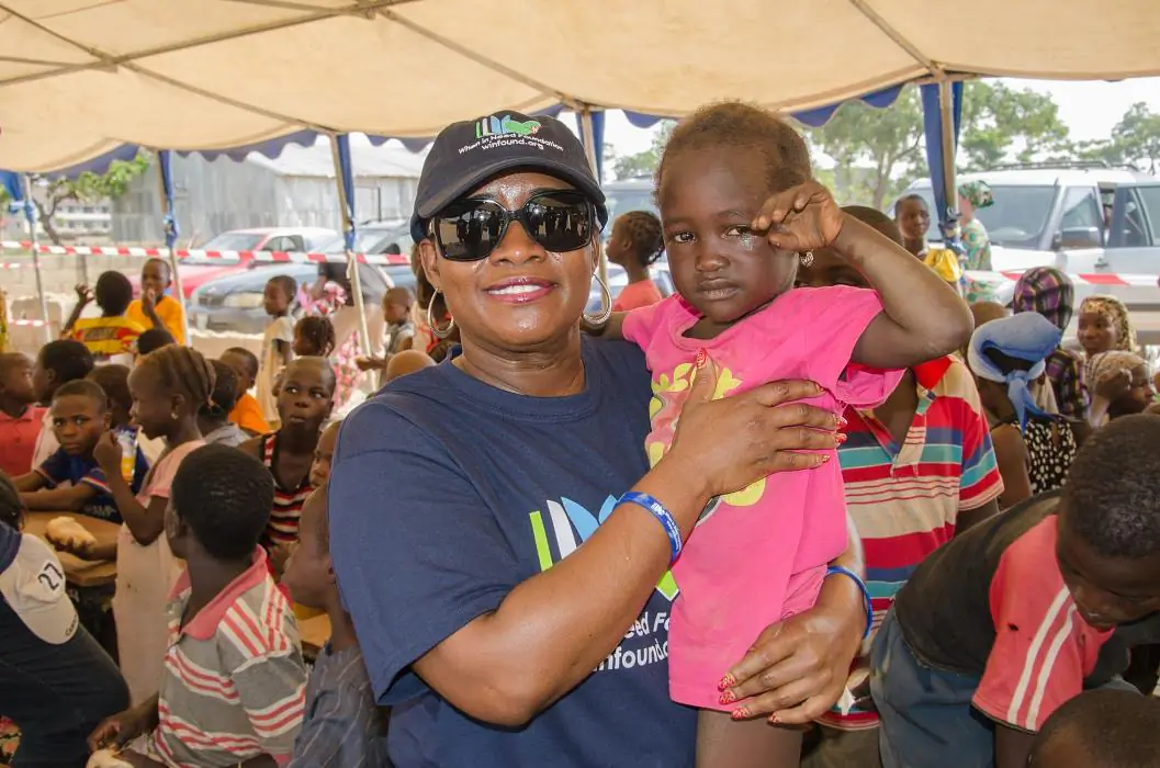 When In Need Foundation President Ms. Chetachi Ecton holds a child at the Kuchingoro IDP camp in the Galadimawa area of Abuja, Nigeria. (When In Need Foundation)