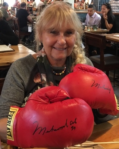  Lina wearing boxing gloves autographed by Ali. (Courtesy of Bruce Barton)