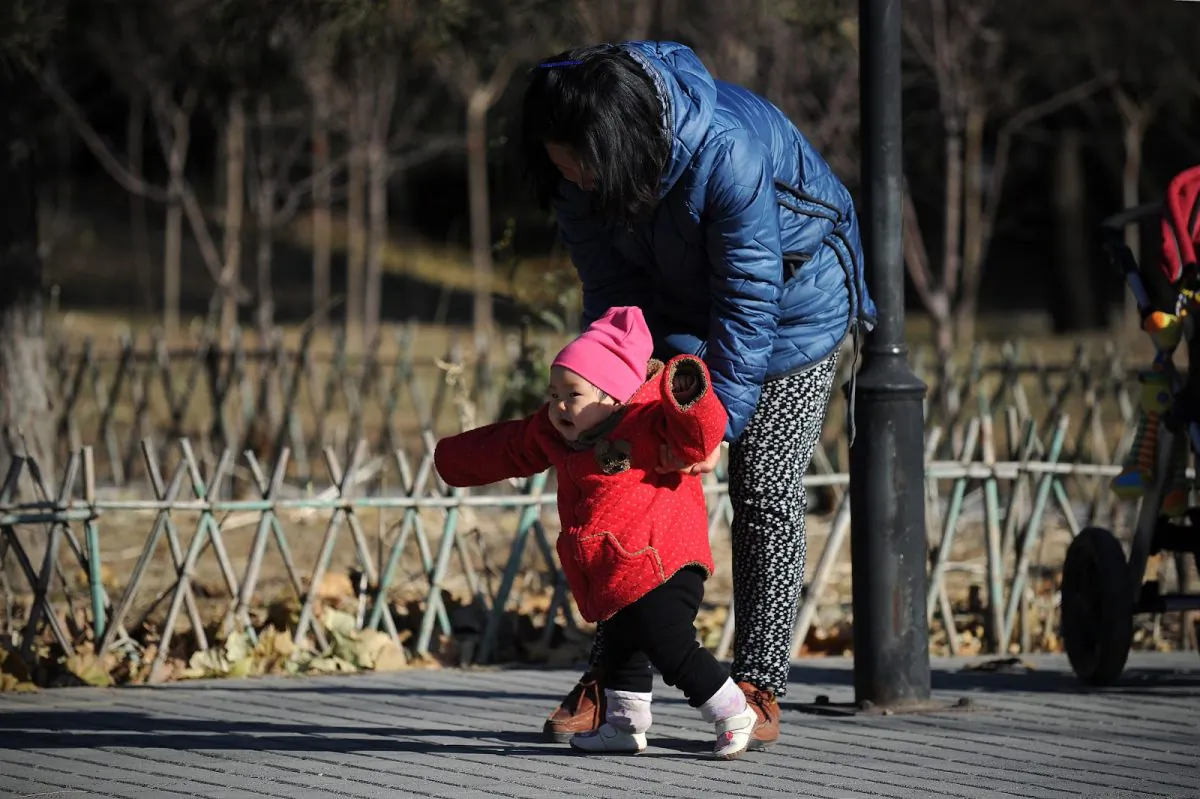 A woman and child walk at a park in Beijing on November 26, 2013. (Wang Zhao/AFP/Getty Images)