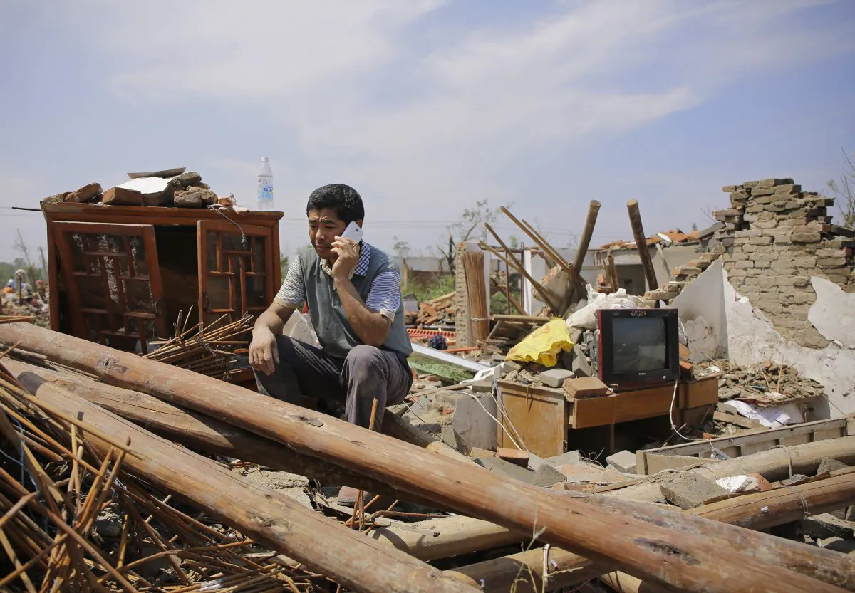 YANCHENG, CHINA - June 25:  
A villager sitting in front of the collapsed house in Danping Village of Yancheng City,  Jiangsu Province. A total of 99 people were killed after severe storms in several towns in Jiangsu on June 23, 2016, with nearly 1,000 injured. (Photo by Wang He/Getty Images)