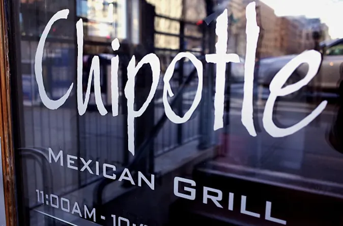 The Chipotle logo is seen on the door of one of its restaurants on January 11, 2015 in Washington, DC. The embattled Mexican fast food chain is under increased scrutiny following outbreaks of foodborn illnesses which lead a decline in share prices. AFP PHOTO/MANDEL NGAN / AFP / MANDEL NGAN (Photo credit should read MANDEL NGAN/AFP/Getty Images)