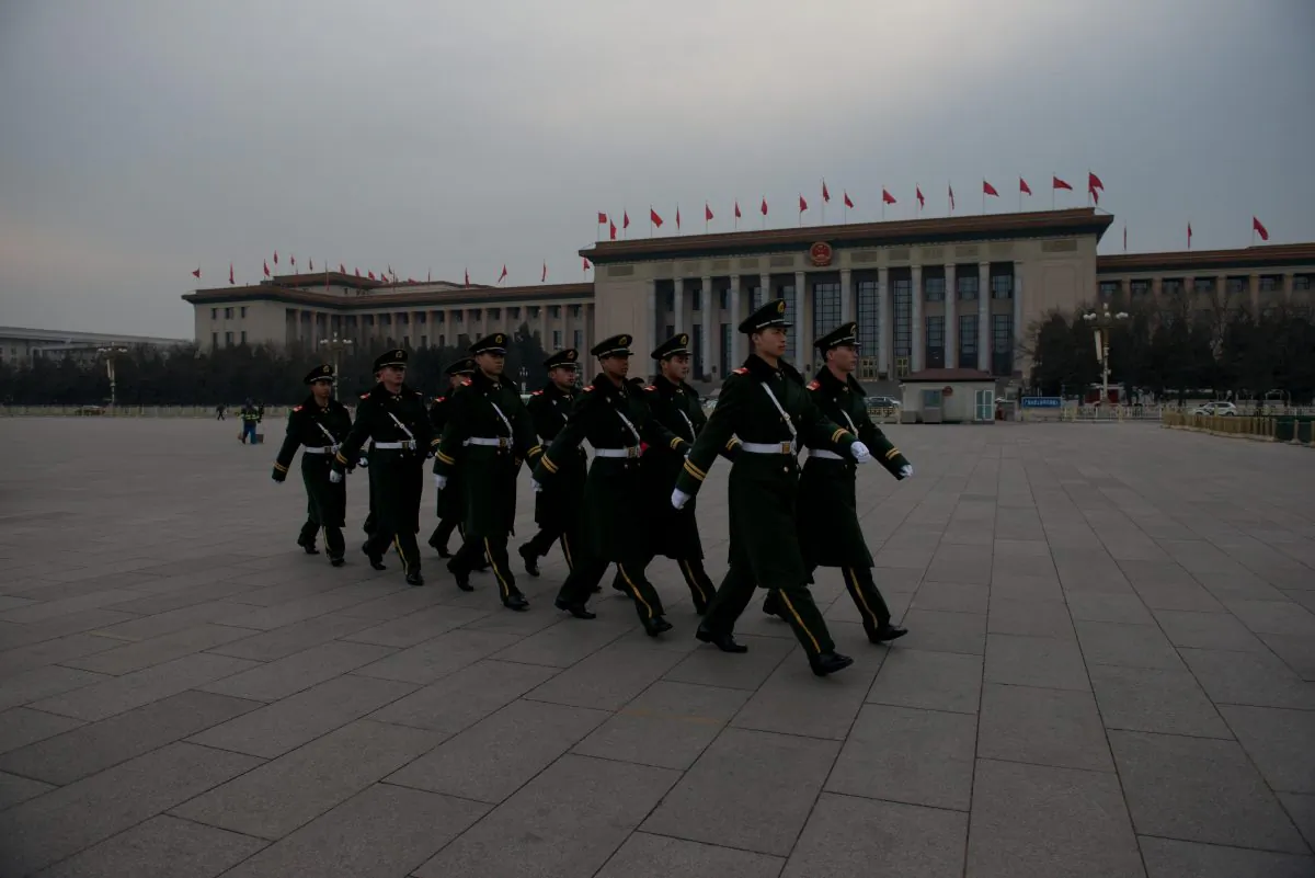 Paramilitary guards walk in Tiananmen Square outside the Great Hall of the People during a press conference of the Chinese People’s Political Consultative Conference (CPPCC) on March 2, 2013. (Ed Jones/AFP/Getty Images)