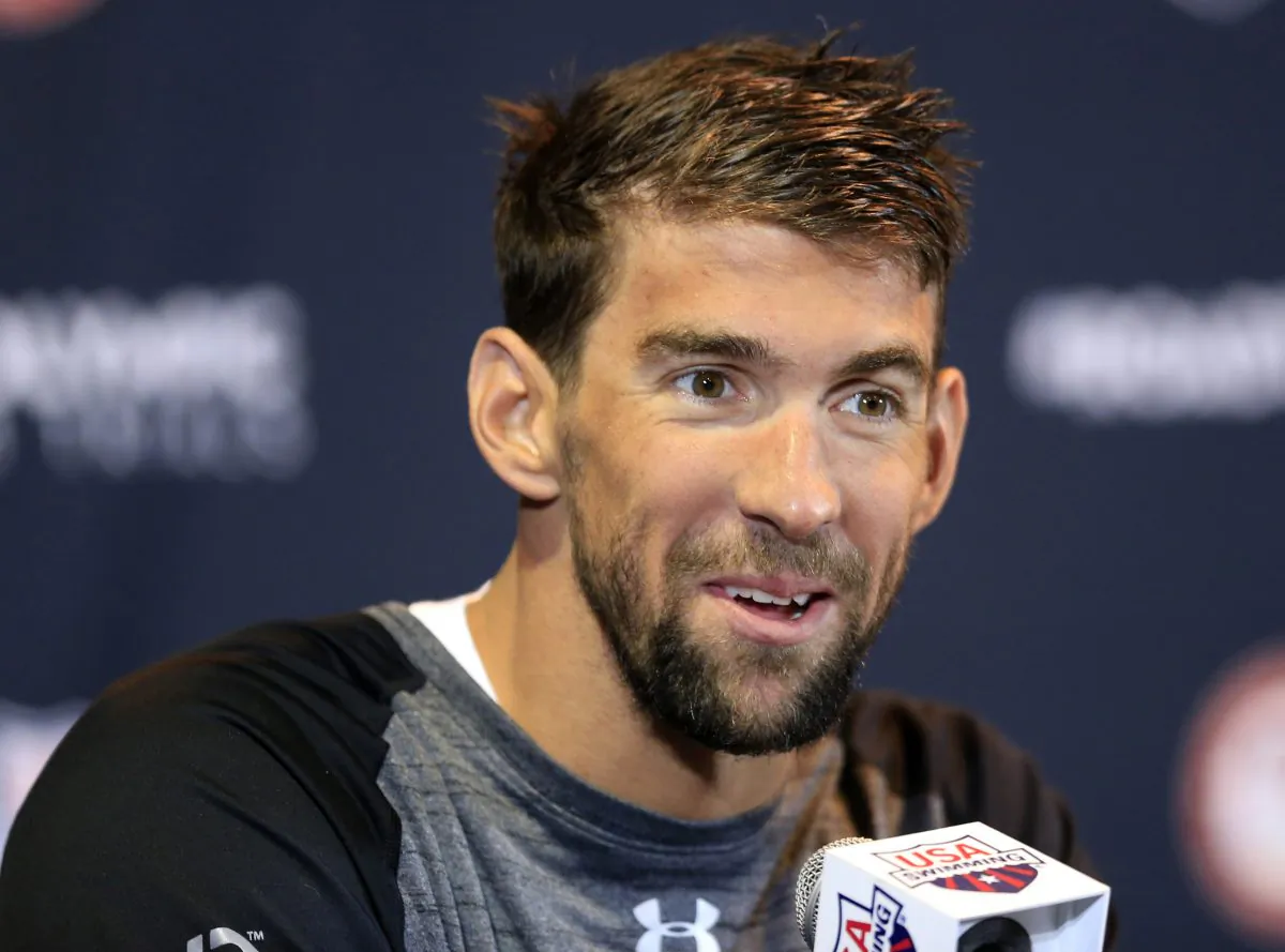 Michael Phelps, who's won 18 Olympic gold medals, is trying to pass on his knowledge to other swimmers as he prepares for his final Olympics. (AP Photo/Orlin Wagner) 
