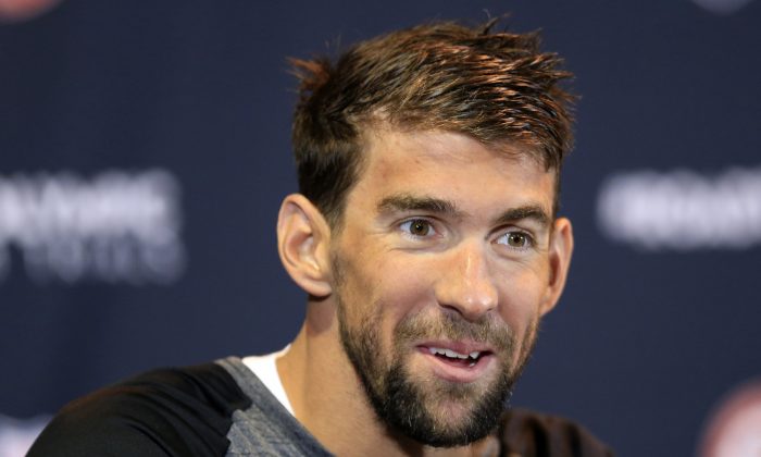 Michael Phelps, who's won 18 Olympic gold medals, is trying to pass on his knowledge to other swimmers as he prepares for his final Olympics. (AP Photo/Orlin Wagner) 