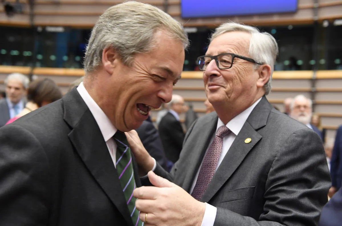 European Commission President Jean-Claude Juncker, right, greets UKIP leader Nigel Farage during a special session of European Parliament in Brussels on June 28, 2016. (AP Photo/Geert Vanden Wijngaert)