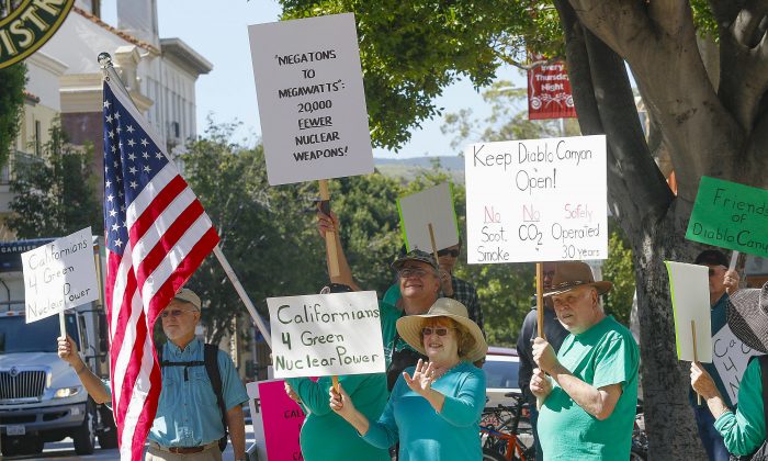 FILE - In this file photo taken, people rally in front of the San Luis Obispo County government building in support of Diablo Canyon nuclear power plant in San Luis Obispo, Calif., on March 17, 2016. (David Middlecamp/The Tribune (of San Luis Obispo) via AP, File)