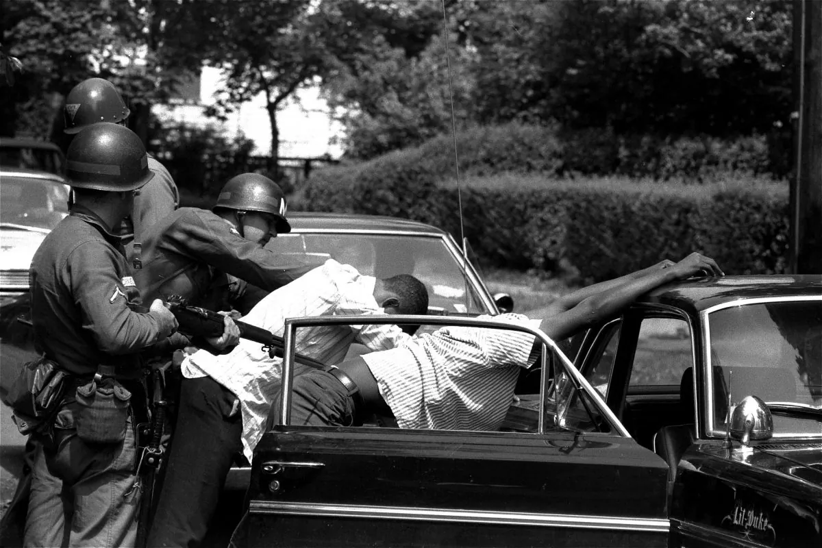 Blacks are searched at a bayonet point by National Guardsmen in Newark, New Jersey, July 17, 1967.  The National Guardsmen entered the riot-torn area of the city at daybreak and searched all cars leaving the riot zone.  A white policeman was shot and died after being beaten and stomped by a gang following the shooting of a 22 year old black man.  (AP Photo/Eddie Adams)