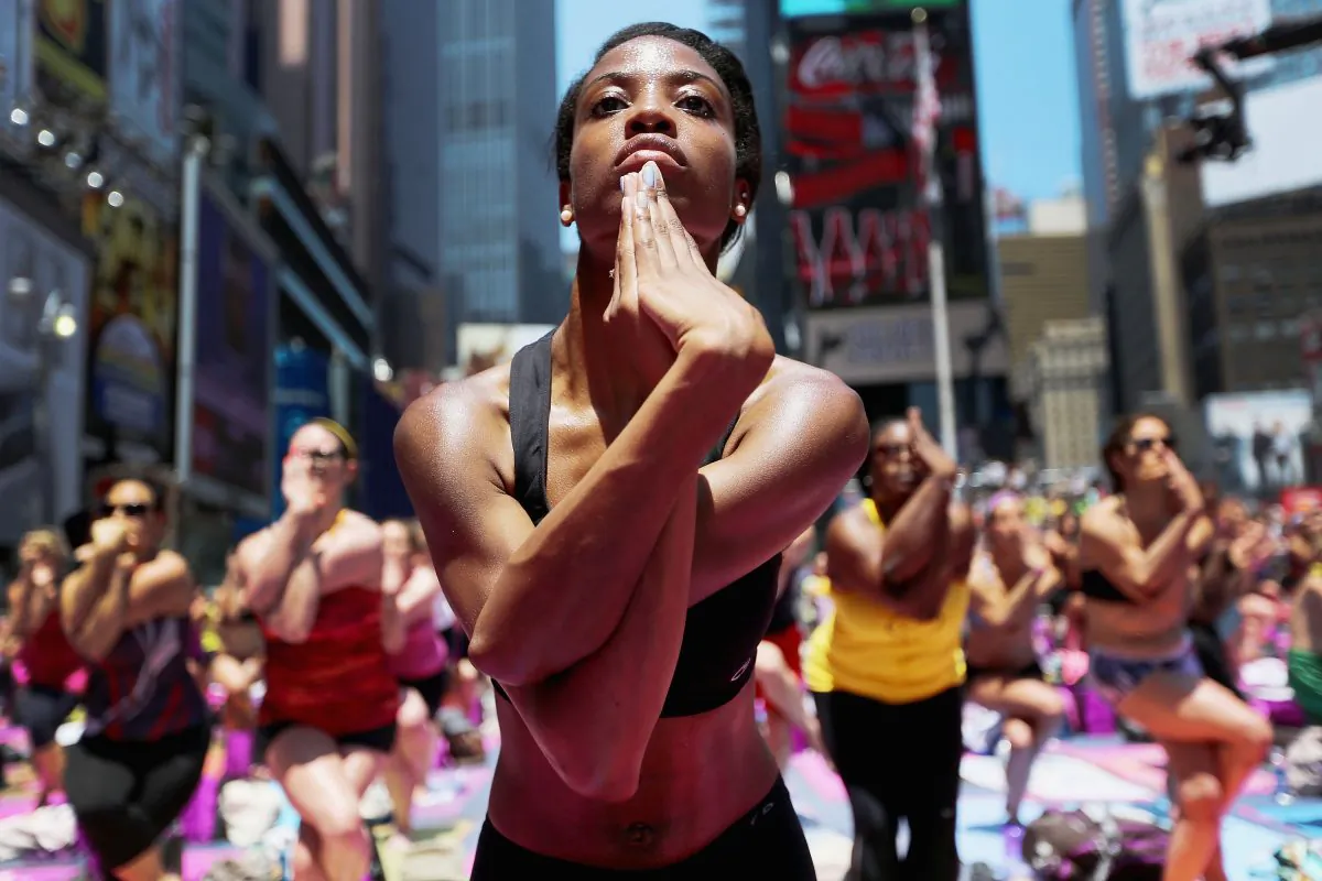 Aisha Johnson (C) and other enthusiasts perform yoga in Times Square during an event marking the summer solstice in New York City on June 21, 2013. (Mario Tama/Getty Images)
