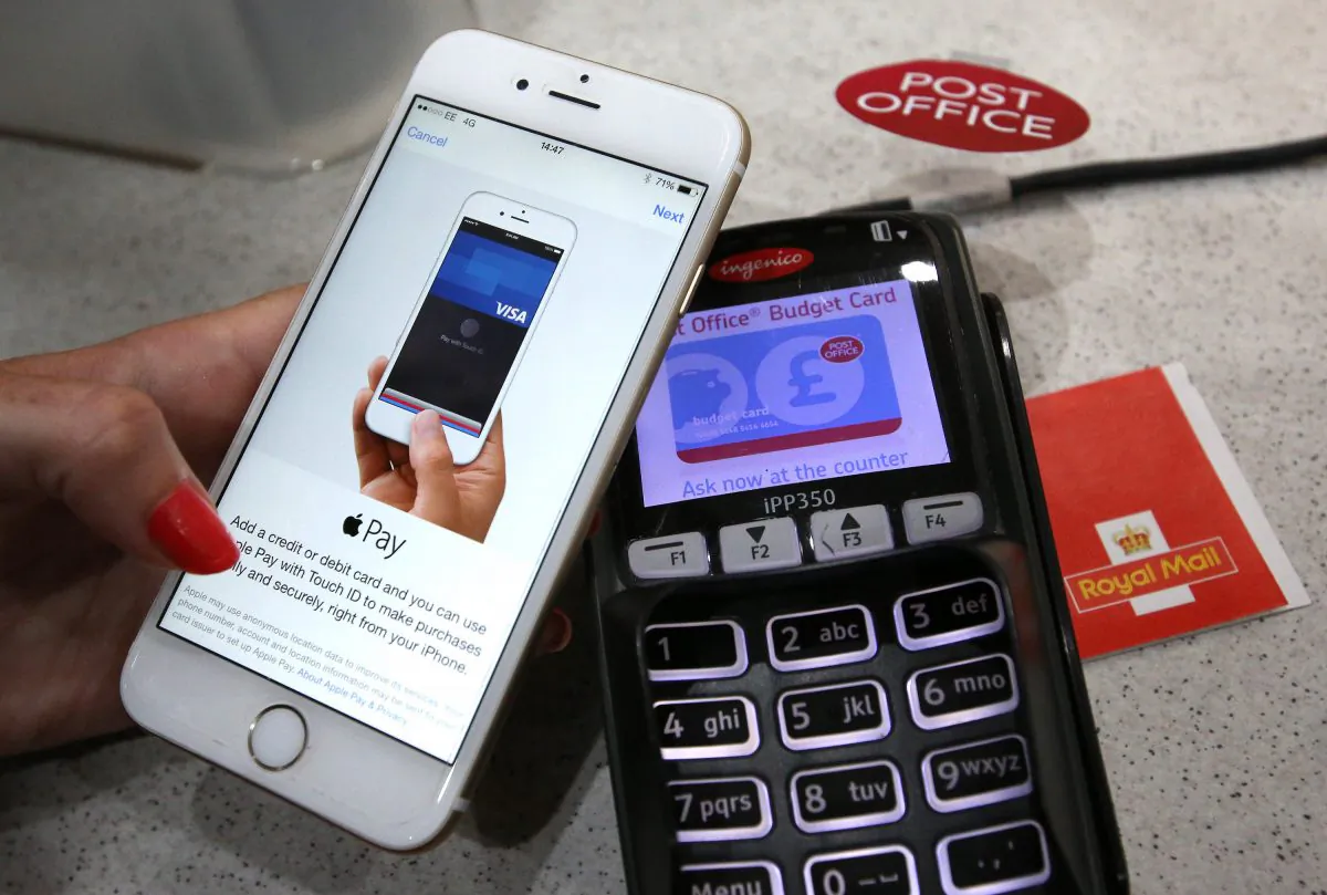 An iPhone is used to make an Apple Pay purchase at The Post Office in London, England, on July 14, 2015. (Peter Macdiarmid/Getty Images)