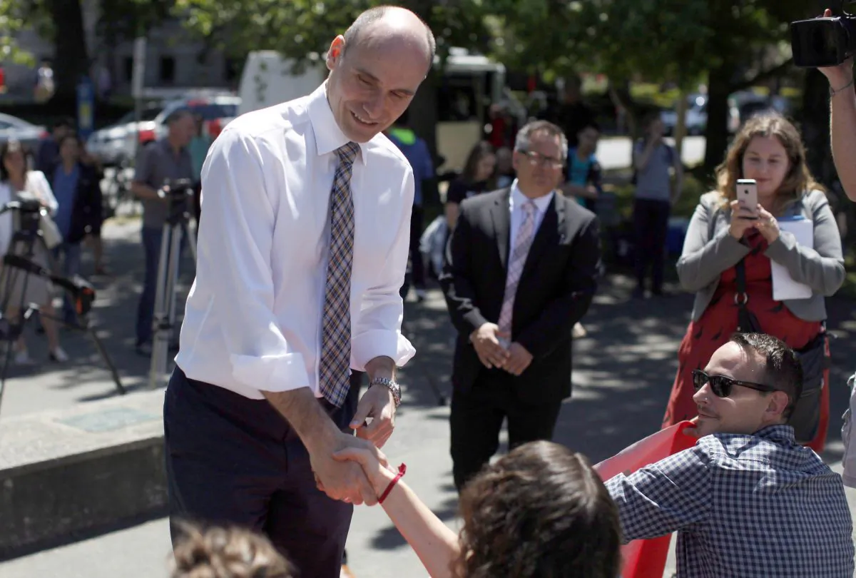 Federal Housing MInister Jean-Yves Duclos meets with housing and homeless advocates, activists, and residents from Victoria's tent city during a protest outside Hotel Grand Pacific in Victoria on June 28, 2016. (The Canadian Press/Chad Hipolito)