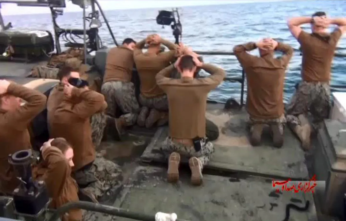 This picture released by the Iranian state-run IRIB News Agency on Wednesday, Jan. 13, 2016, shows detention of American Navy sailors by the Iranian Revolutionary Guards in the Persian Gulf, Iran. Iranian state television is reporting that all 10 U.S. sailors detained by Iran after entering its territorial waters have been released. Iran's Revolutionary Guard said the sailors were released Wednesday after it was determined that their entry was not intentional. (Sepahnews via AP)