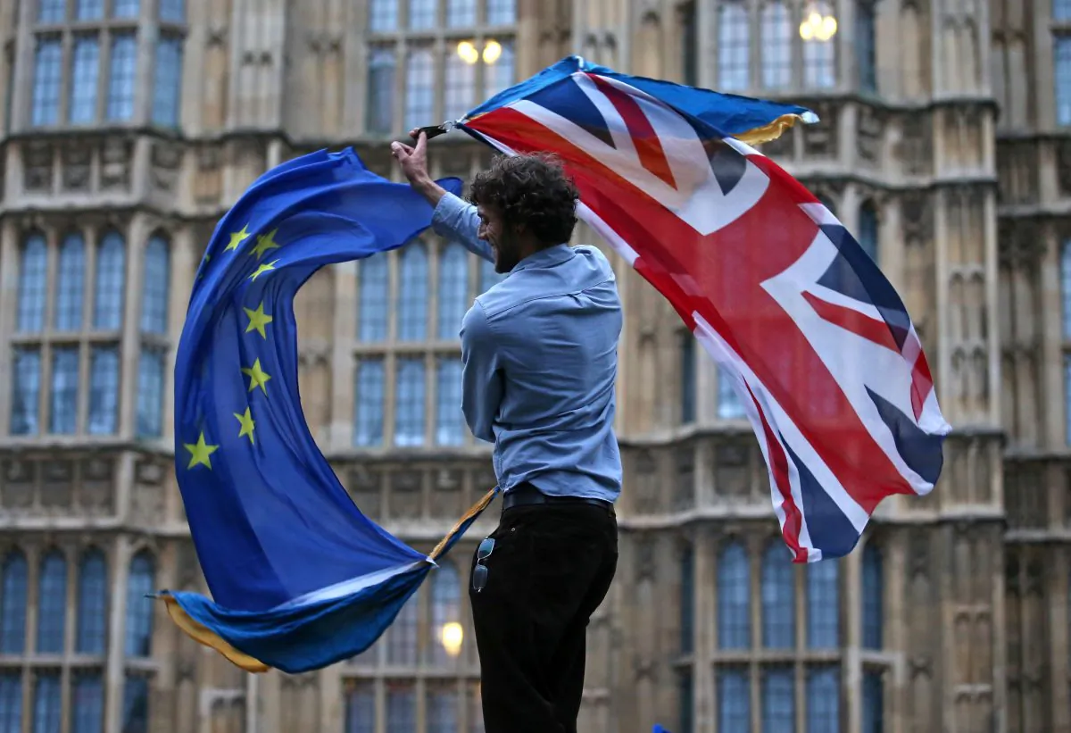 A man waves both a Union flag and a European flag outside The Houses of Parliament at an anti-Brexit protest in central London on June 28. (JUSTIN TALLIS/AFP/Getty Images)