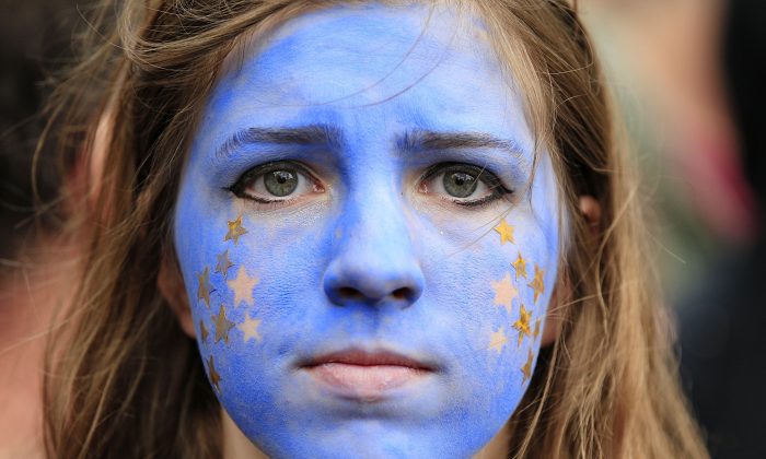 A "Remain" supporter, her face painted to resemble the EU flag, walks on Park Lane in London, as protesters marched to Parliament Square to show their support for the European Union in the wake of last weeks referendum decision for Britain to leave the EU, known as "Brexit," on July 2, 2016. (Jonathan Brady/PA via AP)