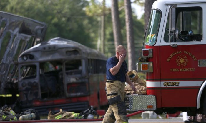 Wakulla County first responders work on the scene of an accident on Saturday, July 2, 2016 in Wakulla, Fla.  The Florida Highway Patrol says a bus and tractor trailer collided on a highway in the Panhandle. Florida Highway Patrol Capt. Jeffrey Bissainthe says the bus was carrying between 30 and 35 passengers and was from Georgia.   (Joe Rondone /Tallahassee Democrat via AP)