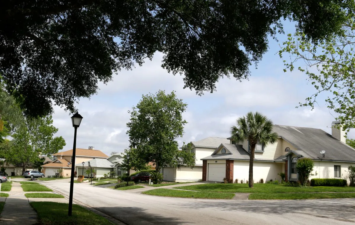 A view of a street in the Piedmont Park neighborhood in Apopka, Fla., on April 14, 2016. Many of the single-family homes in the neighborhood used to be owned by families, but now they're owned by companies associated with big real estate investment firms. And the occupants are tenants, not owners. (AP Photo/John Raoux)