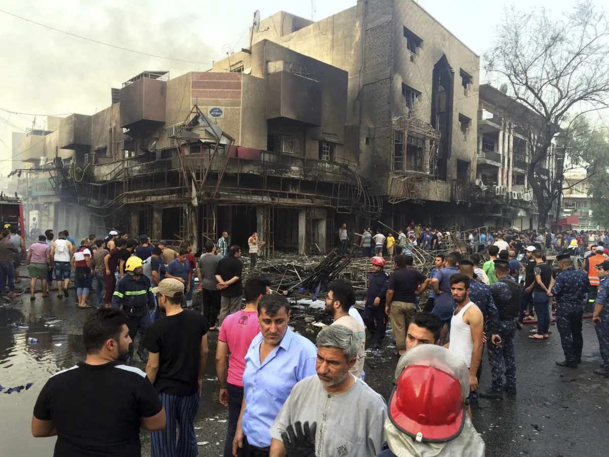 Iraqi security forces and civilians gather at the site after a car bomb at a commercial area in Karada neighborhood, Baghdad, Iraq, on July 3, 2016. Bombs went off early Sunday in two crowded commercial areas in Baghdad. (AP Photo/Khalid Mohammed)
