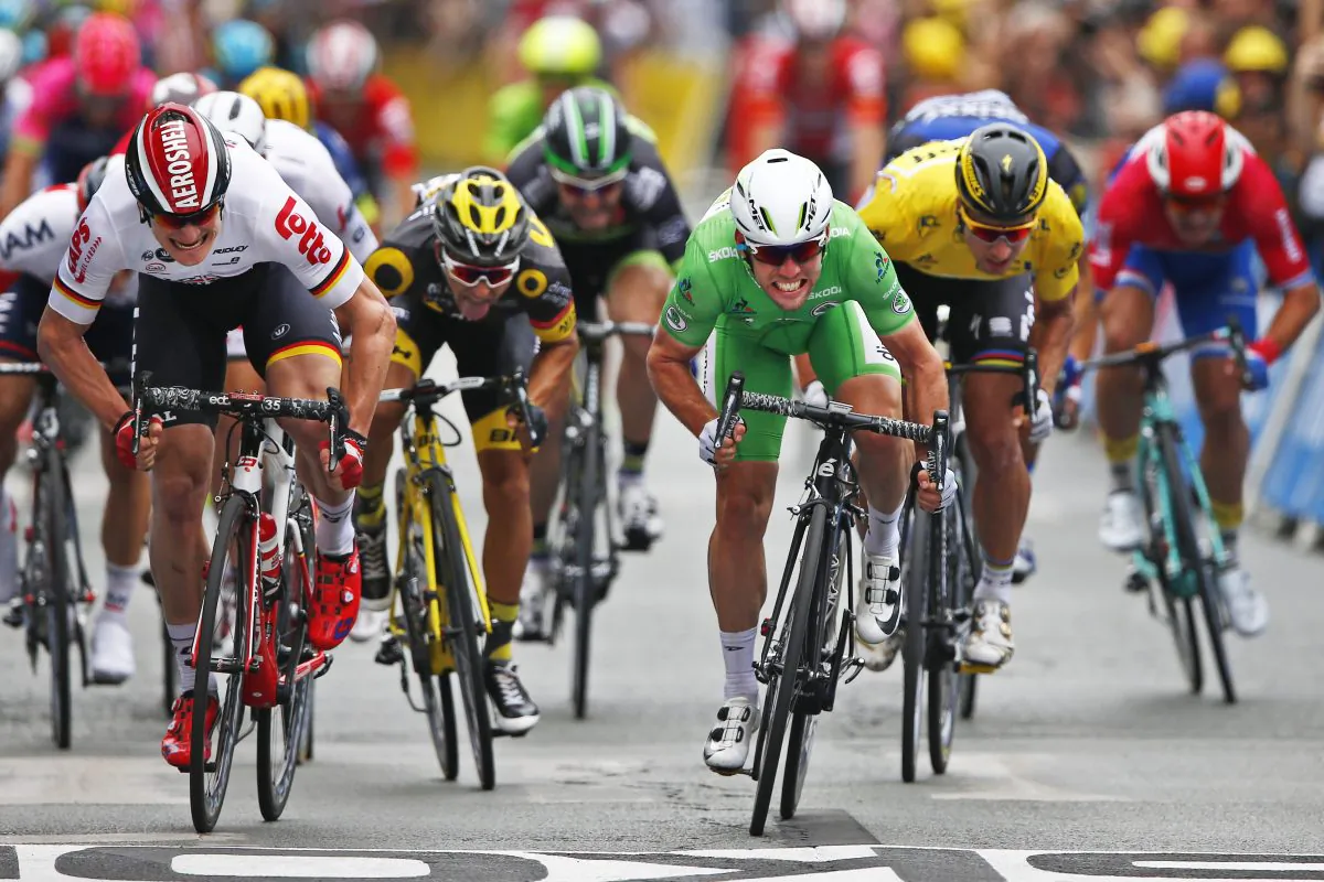 Dimension Data’s Mark Cavendish, wearing the best sprinter's green jersey, crosses the finish line ahead Lotto-Soudal's Andre Greipel, left, and Peter Sagan of Tinkoff, wearing the overall leader's yellow jersey, to win Stage 3 of the Tour de Franc, 223.5 kilometers (138.6 miles) from Granville to Angers, France, Monday, July 4, 2016. (AP Photo/Peter Dejong)