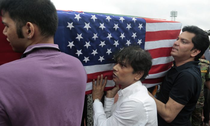 Relatives of Abinta Kabir, student of Emory University of U.S., carry her coffin draped with the Bangladesh and U.S. flags after a ceremony for victims of the attack on the Holey Artisan Bakery, in Dhaka, Bangladesh, Monday, July 4, 2016. The brutality of the attack, the worst convulsion of violence yet in the recent series of deadly attacks to hit Bangladesh, has stunned the traditionally moderate Muslim nation and raised global concerns about whether it can cope with the increasingly strident Islamist militants. (AP Photo)