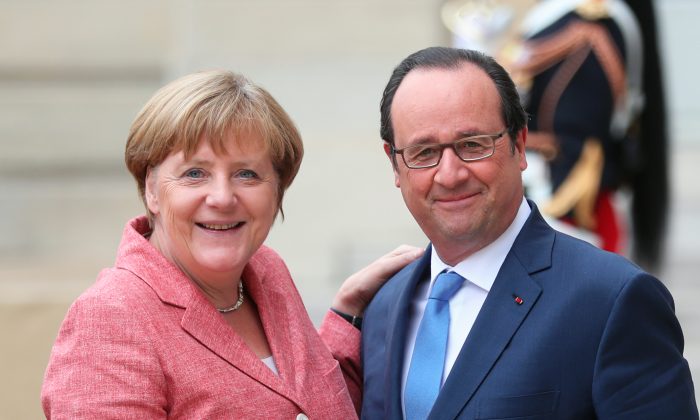 France's President Francois Hollande, right, poses with German Chancellor Angela Merkel, prior to the Balkans summit, at the Elysee Palace, in Paris, Monday, July 4, 2016. The leaders of France, Germany, Italy and Balkan nations are meeting to better prevent extremists from sneaking in with migrants who are moving west across Europe. (AP Photo/Thibault Camus)