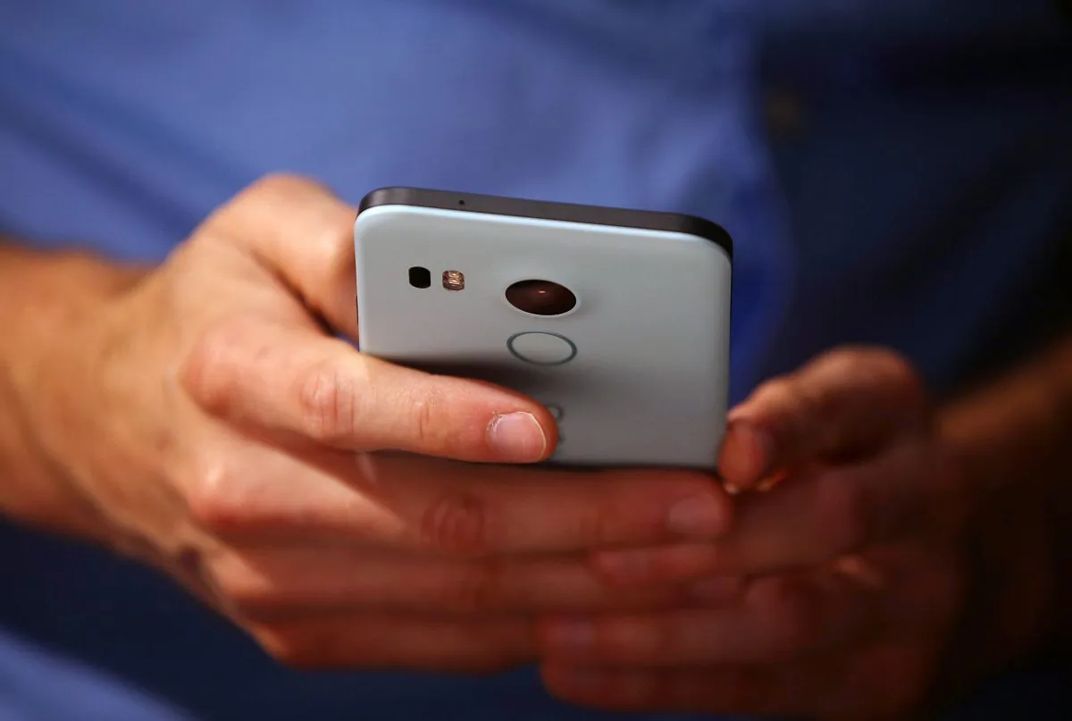 A person holds a phone in San Francisco, California, on Sept. 29, 2015. (Justin Sullivan/Getty Images)