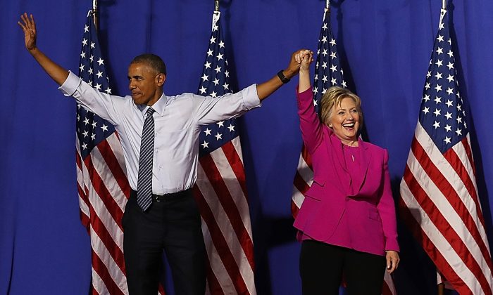 Democratic presidential candidate Hillary Clinton and President Barack Obama greet supporters during a campaign rally in Charlotte, North Carolina, on July 5, 2016. (Justin Sullivan/Getty Images)