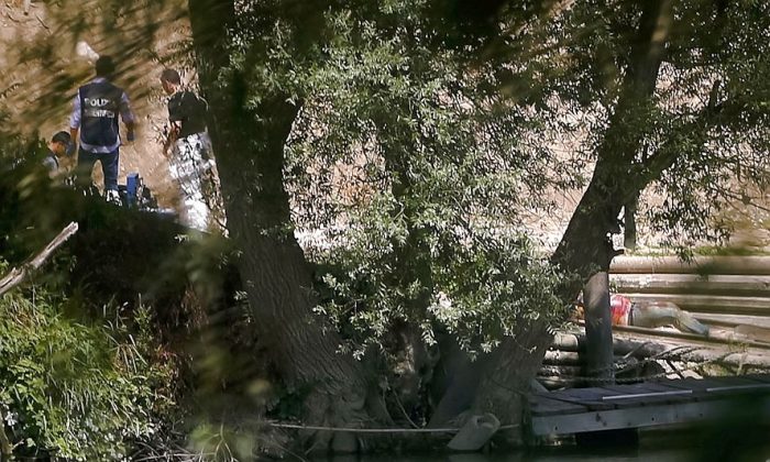 The body of a young man, right, lies on the banks of the Tiber river in Rome, Monday, July 4, 2016. Italian authorities on Monday were investigating the disappearance of a Wisconsin student in Rome a day after he arrived in the Italian capital. Police reported the discovery of the body of a young male in the Tiber river in Rome but stressed no identification of the corpse had been made, and thus it was impossible to say if the development might be part of the case of the missing student (AP Photo)