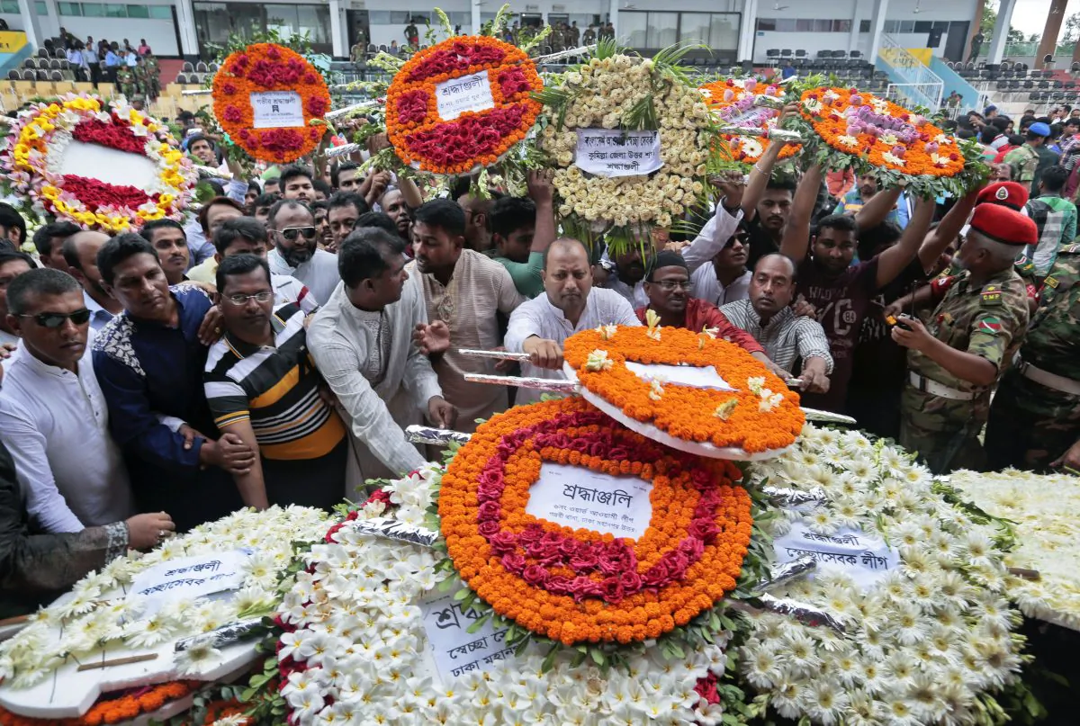 Local residents pay their respects to the victims of the attack at the Holey Artisan Bakery in Dhaka, Bangladesh, on July 4, 2016. The assault on the restaurant in Dhaka's diplomatic zone by militants who took dozens of people hostage marks an escalation in militant violence in the Muslim-majority nation. (AP Photo)