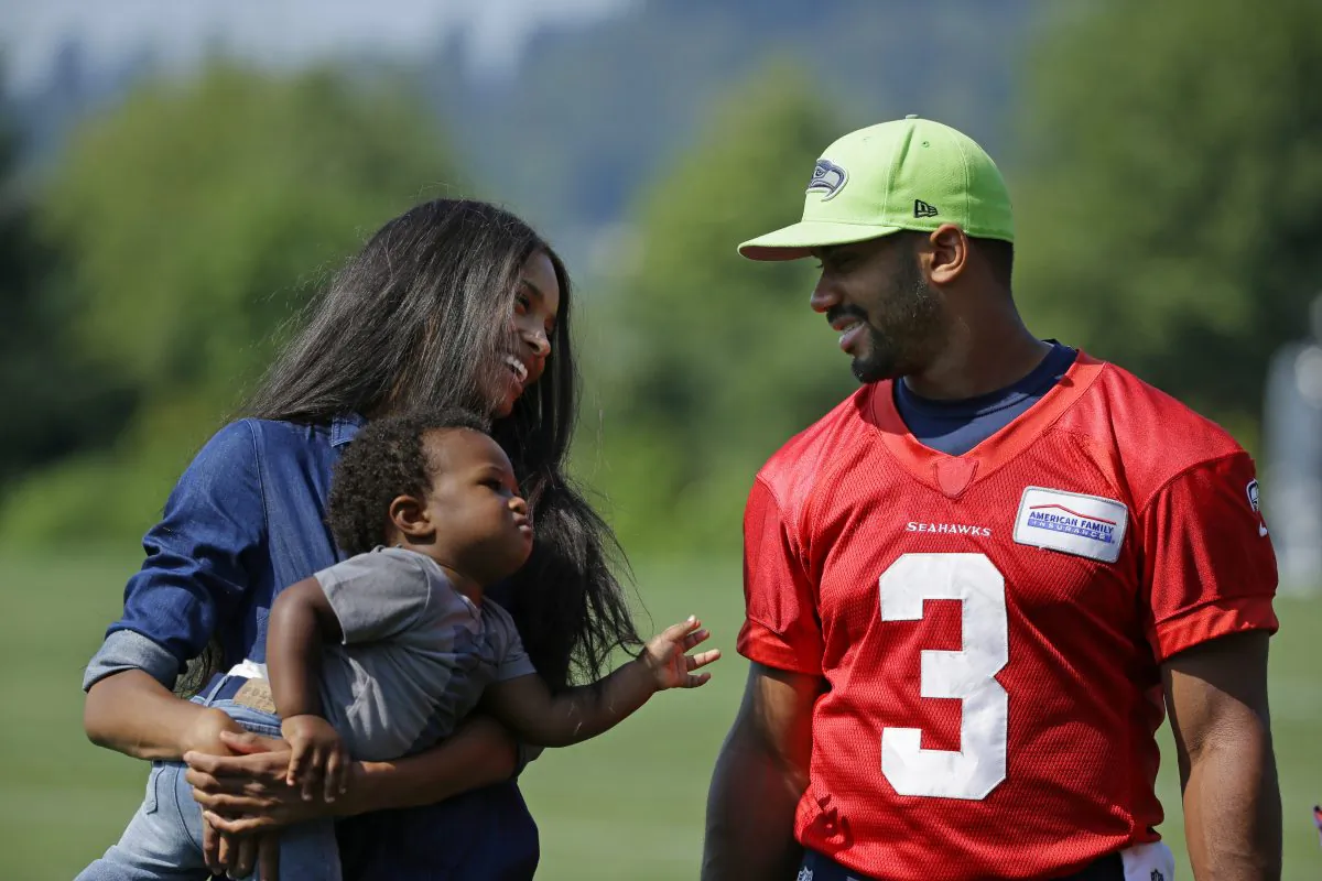 Seattle Seahawks quarterback Russell Wilson, (R) walks with his girlfriend, entertainer Ciara Harris, and Harris' son Future on Aug. 13, 2015. (AP Photo/Ted S. Warren)