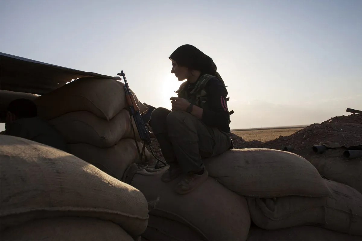A fighter of the Kurdish of the Kurdish Women's Defense Units (YPJ) sits on sand bags as she holds a position on the front line in the Kurdish town of Derik (al-Malikiyah in Arabic), in the northeastern Hasakeh governorate on the border with Turkey and Iraq, on Oct. 19, 2013. Kurdish fighters from several villages in oil-rich Hasake province are engaged in combat against al-Qaida affiliated groups the Islamic State of Iraq and Syria (ISIS) and Nusra Front, said the Syrian Observatory for Human Rights. (Fabio Bucciarelli/AFP/Getty Images)