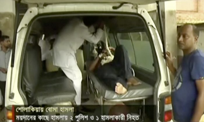 In this image made from video provided by Jamuna TV, injured people are assisted after a militant attack in Kishoreganj, about 90 kilometers (60 miles) north of the capital of Dhaka, Bangladesh, Thursday, July 7, 2016. Islamic extremists hurled homemade bombs and engaged in a gunbattle with police guarding a large Eid prayer at the end of the holy Muslim month Thursday morning. The violence comes just days after a deadly hostage crisis at a restaurant in Dhaka. (Jamuna TV via AP Video)