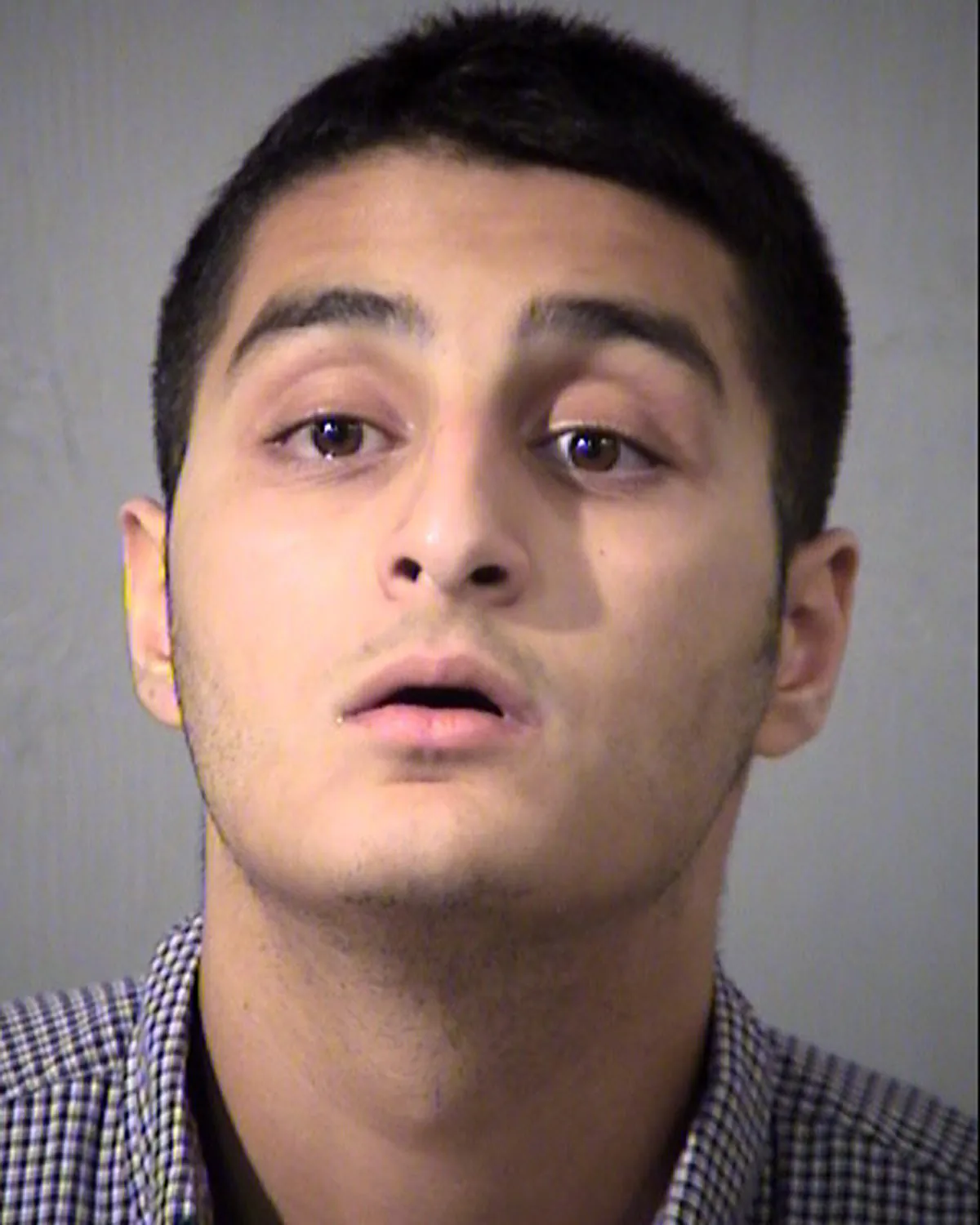 This mugshot taken Friday, July 1, 2016 and provided by the Maricopa County Sheriff's Office shows Mahin Khan, of Tucson, Ariz. Khan has been arrested by the FBI and the Arizona Attorney General's Office for threatening to commit acts of terrorism on government buildings in Tucson and Phoenix. (Maricopa County Sheriff's Office via AP)