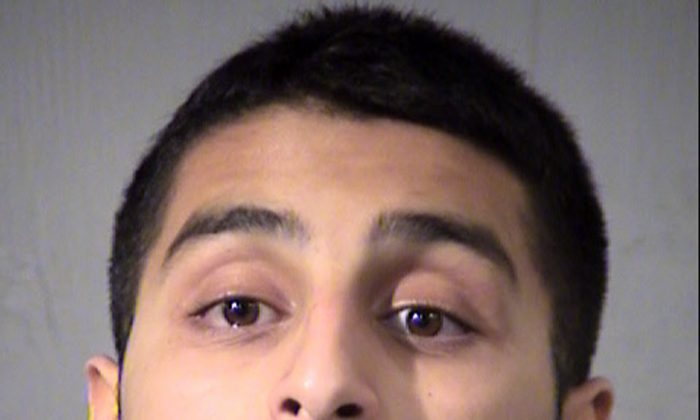 This mugshot taken Friday, July 1, 2016 and provided by the Maricopa County Sheriff's Office shows Mahin Khan, of Tucson, Ariz. Khan has been arrested by the FBI and the Arizona Attorney General's Office for threatening to commit acts of terrorism on government buildings in Tucson and Phoenix. (Maricopa County Sheriff's Office via AP)