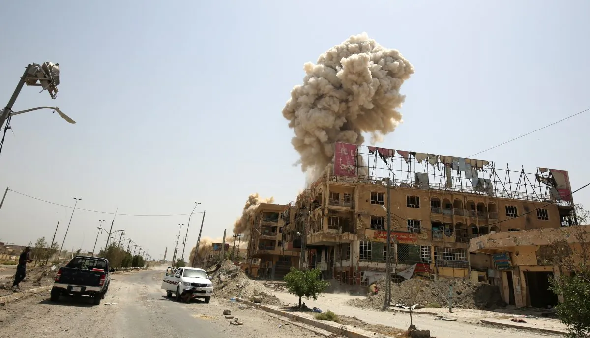 TOPSHOT - Smoke rises in the city of Fallujah on June 30, 2016 as Iraqi forces destroy a booby-trapped building after they've recaptured the city from Islamic State (IS) group jihadists.
Iraqi forces have retaken full control of Fallujah, a longtime jihadist bastion just 50 kilometres (30 miles) west of Baghdad, after a vast operation that was launched in May. / AFP / AHMAD AL-RUBAYE (Photo credit should read AHMAD AL-RUBAYE/AFP/Getty Images)