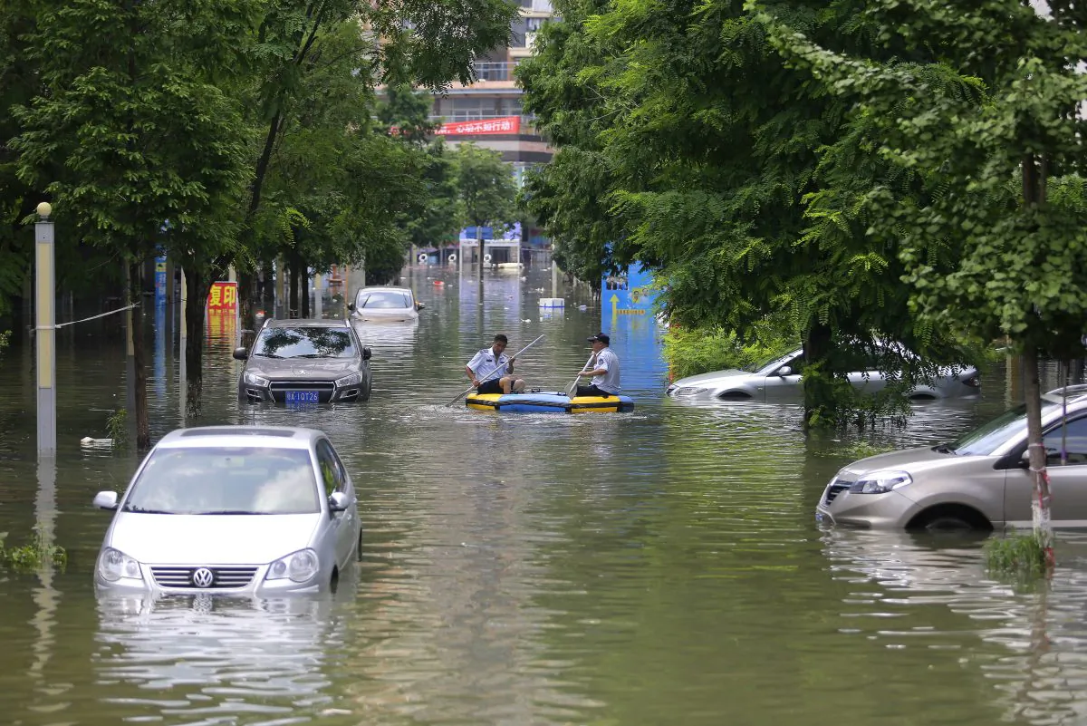 Rescuers on inflatable boats in the flooded of South Lake community of Wuhan, central China, on July 7 2016. (Wang He/Getty Images)