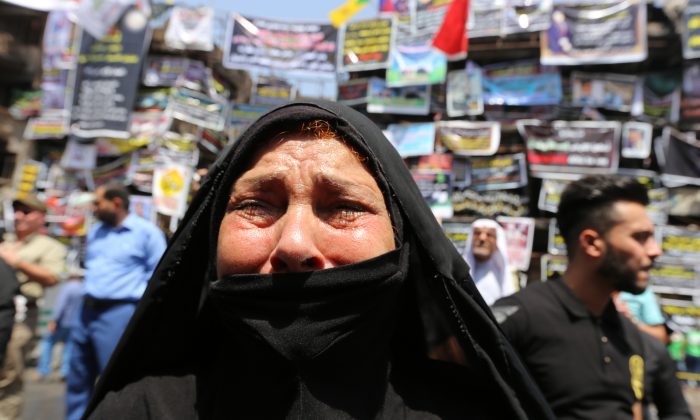 An Iraqi woman cries on July 7th, 2016, in front of a memorial for the victims of a suicide bombing which claimed the lives of over 200 people in Baghdad's Karrada neighbourhood.
 (SABAH ARAR/AFP/Getty Images)